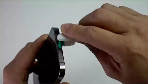 Cleaning the charging port with a toothbrush